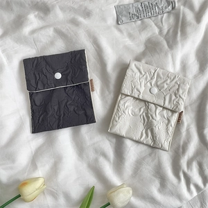 Detail of floral texture storage bags in grey and white with secure snap button