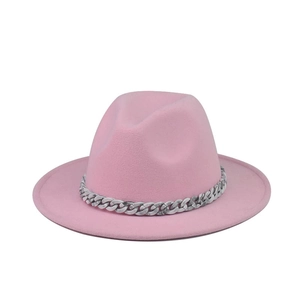Detail of pink wool fedora hat featuring a unique grey marble pattern chain decoration