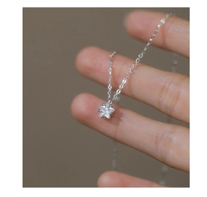 Macro shot of silver star pendant with sparkling zircon on a delicate O-chain necklace