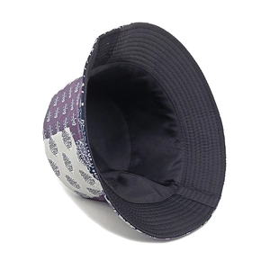 Detail of paisley print bucket hat showing reversible fabric and reinforced brim stitching