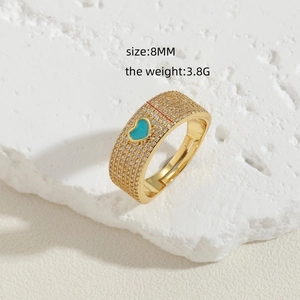 Detail of 8mm gold wide band ring with blue heart enamel and sparkling cubic zirconia stones