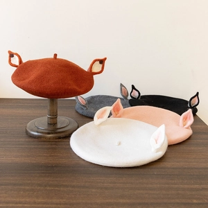 Detailed display of wool felt berets with animal ears in multiple autumn colors