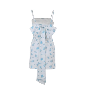 Detail of elegant blue floral dress featuring a large decorative back bow and long ribbons