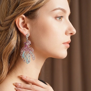 Vintage crystal goldfish drop earrings with sparkling rhinestone gradients on model
