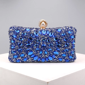 Macro detail of luxury evening clutch with blue and silver floral rhinestones and pearl clasp