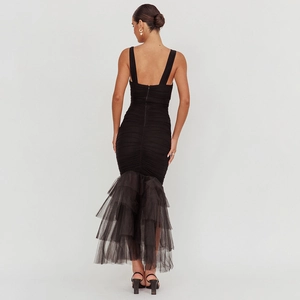 Detail of back zipper and multi-layer tulle mermaid hem on black bodycon dress