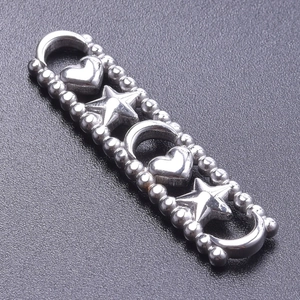 Detailed macro of stainless steel heart and star connector charms for DIY jewelry making