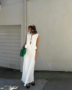 Detail of white cotton linen two-piece set featuring sleeveless tie-up top and long skirt