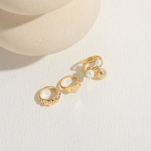 Three-piece gold-plated ring set with pearls, star geometry and twisted rope bands