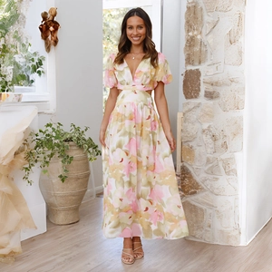Detail of floral maxi dress showing side waist cutouts and light puff sleeves