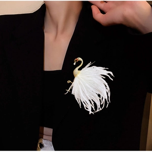 Elegant crane brooch with gold metal neck, zircon crystals and soft white feathers