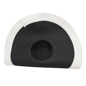 Detailed weave pattern of wide brim straw hat with black crown and white edging