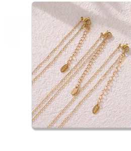 Close-up of gold stainless steel extension chains with lobster clasps and S.Steel tags