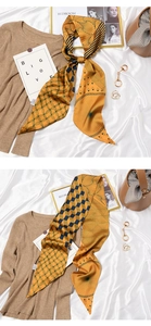Detail of yellow geometric silk scarf styled with a brown knit sweater and golden jewelry