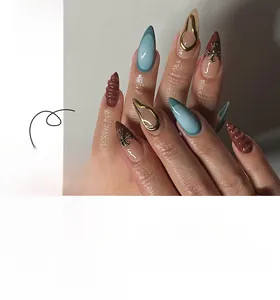 Detail of Stiletto press-on nails with 3D chrome crosses and blue french tips