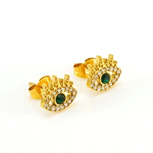 Close-up of golden evil eye stud earring with green zircon center and white crystal halo