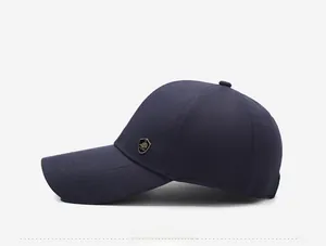 Side view of navy blue baseball cap with gold shield logo and reinforced brim stitching