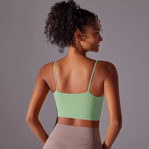 Pale green yoga tank top with thin straps and low back design for women fitness