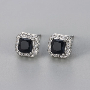 Close-up of square black zircon earrings with sparkling micro-pave halo setting