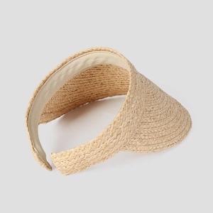 Detail view of woven raffia sun hat showing inner sweatband and tight straw texture
