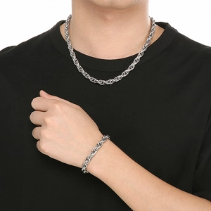 Minimalist silver hammered curb chain necklace and bracelet set worn on a male model