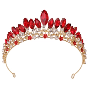 Macro shot of gold wedding crown detailing red marquise crystals and white rhinestones