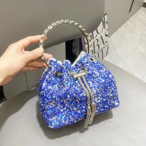Close-up of sparkling blue rhinestone bucket bag with silver metal ring handle