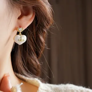 Elegant gold-plated heart drop earrings with white enamel and sparkling zircon stones