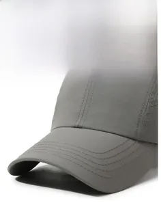 Macro detail of a gray quick-dry baseball cap featuring a stiff brim and reinforced stitching