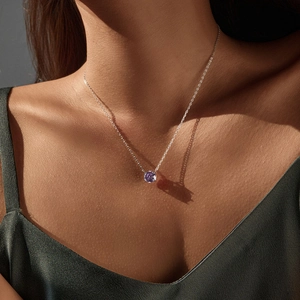 S925 silver necklace with lavender round cut stone on a model with elegant shadows