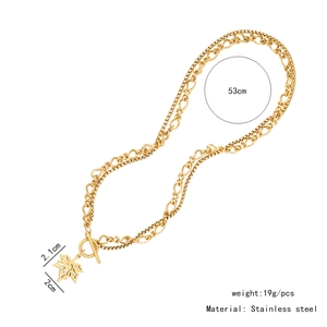 Detailed view of gold maple leaf pendant with T-bar clasp and dimension measurements