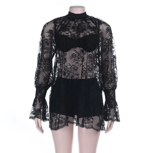 Close-up of intricate black lace patterns on long sleeve sheer top with a matching inner set