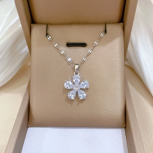 Detailed view of flower pendant necklace with pear-cut zircons in a luxury velvet gift box