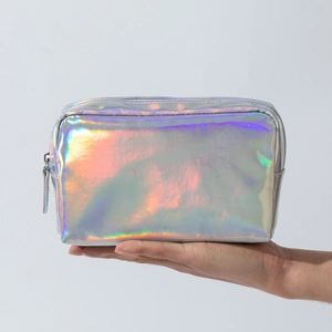 Detailed view of the shiny holographic laser finish on a portable square makeup bag