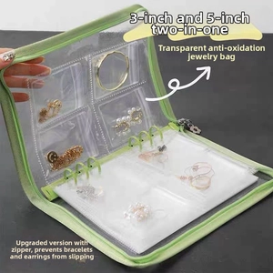 Detail of light green jewelry storage book with PVC pockets for necklaces and rings