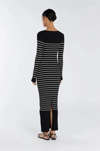 Detail of elegant black and white striped knit maxi dress with a back slit design