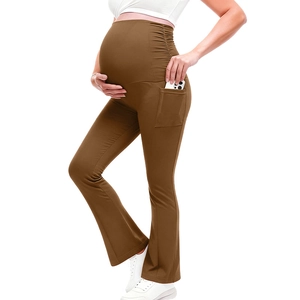 Detail of brown high-waisted maternity yoga pants with side pocket and stretchy fabric