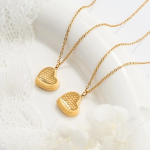 Golden honeycomb heart pendant necklace with forever engraving on white lace background