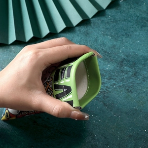 Portable green PU leather eyewear pouch with squeeze-to-open metal closure and print