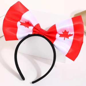 Detail of Canadian flag themed bow headband with iconic red maple leaf pattern