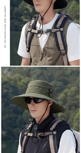 Detail of army green sun hat with decorative compass and adjustable drawstring for outdoor hiking