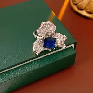 Exquisite flower ring with blue zircon center and pavé petals in vintage palace style