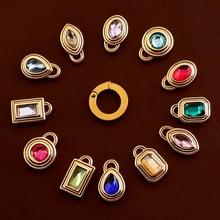 Detailed view of colorful multi-shape gemstone pendants with gold plated metal base