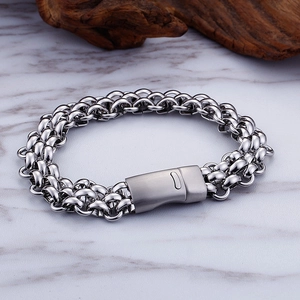 Detail shot of industrial hip hop style stainless steel link bracelet on marble background