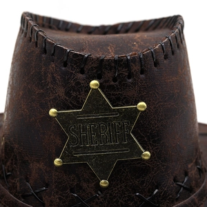Close-up of vintage brown sheriff cowboy hat with star badge and cracked leather texture