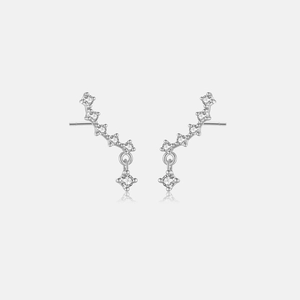 Macro detail of S925 silver curved stud earrings with shiny zircon stones and drop pendant