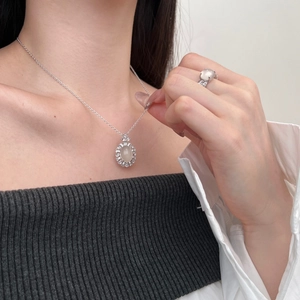 Close-up of S925 sterling silver jewelry set featuring oval stones and diamond halo