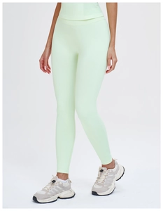 Detail showing the light green high-waisted ribbed waistband of the yoga leggings