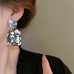 Abstract portrait drop earrings with black and white artistic pop art illustration
