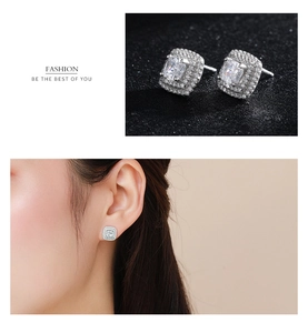Detail of 925 sterling silver halo stud earrings featuring sparkling square cut zircon